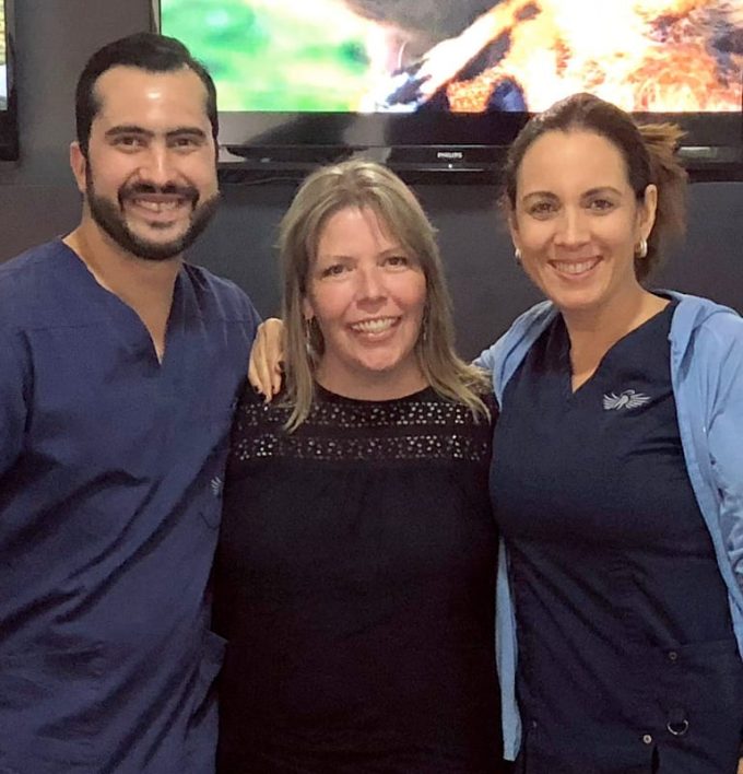 Dr. Andres Brenes, prothodontist and Dr. Karen Yurell, Patient Coordinator with a happy patient